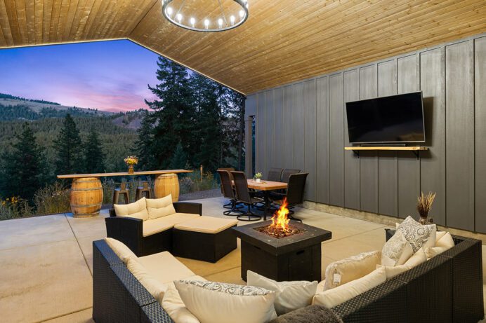 A luxurious patio with a modern firepit and lounge space.